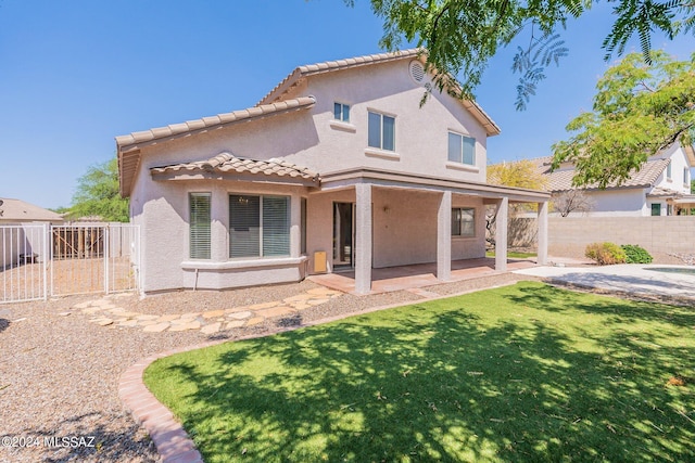 rear view of property featuring a patio area and a lawn