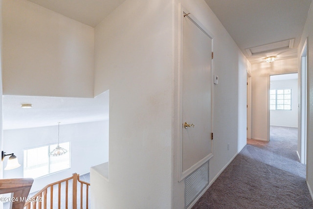 hallway with dark carpet