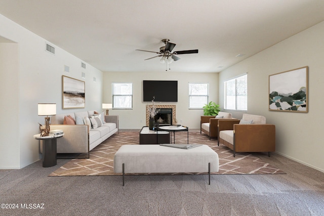 carpeted living room with ceiling fan