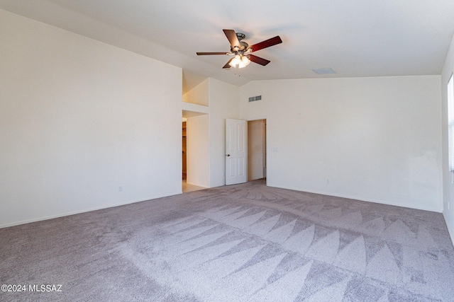 empty room featuring lofted ceiling, ceiling fan, and carpet flooring