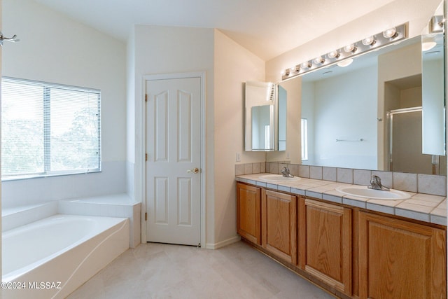 bathroom with vanity and separate shower and tub