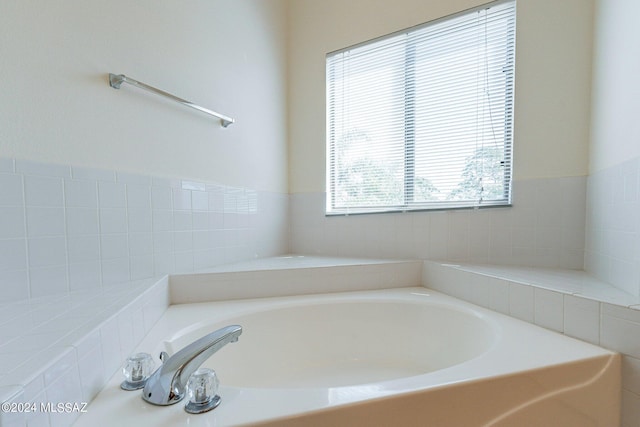 bathroom with tiled tub