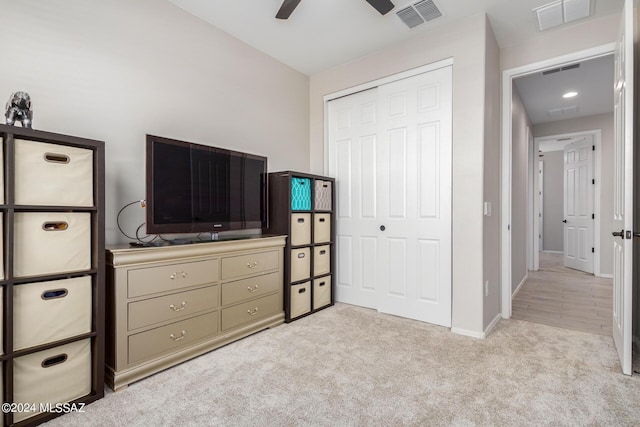 carpeted bedroom with a closet and ceiling fan