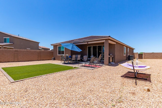 back of house with central air condition unit and a patio area