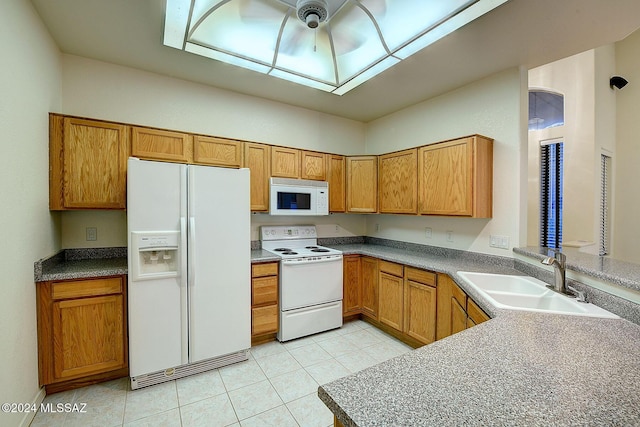 kitchen with light tile patterned flooring, white appliances, ceiling fan, and sink