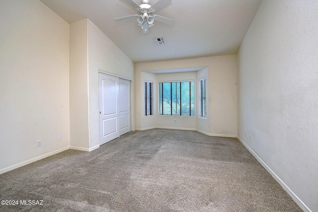 unfurnished bedroom featuring carpet, vaulted ceiling, and ceiling fan