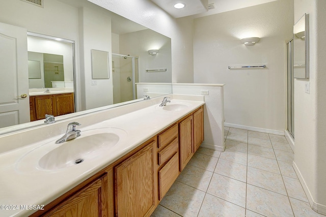 bathroom with tile patterned floors, vanity, and an enclosed shower