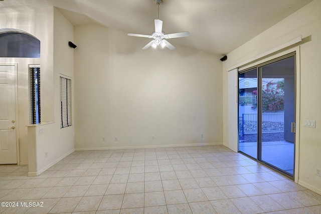 empty room with ceiling fan, light tile patterned floors, and lofted ceiling