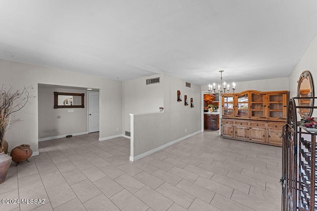 interior space featuring light tile patterned floors, baseboards, visible vents, and a chandelier