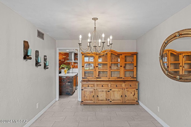 dining space with visible vents, a notable chandelier, and baseboards