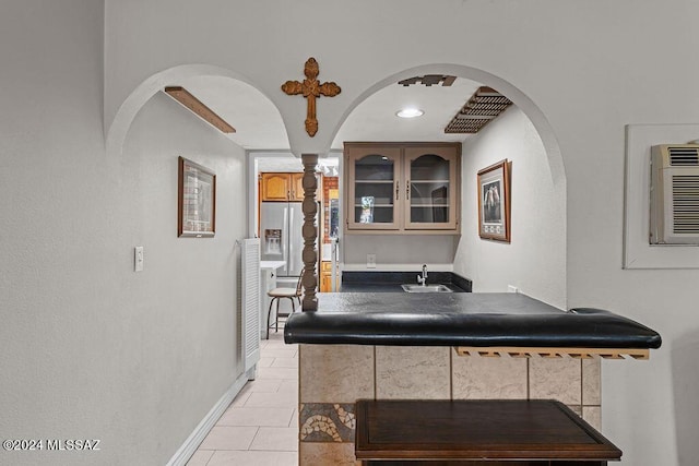 bathroom with tile patterned flooring, baseboards, and a sink