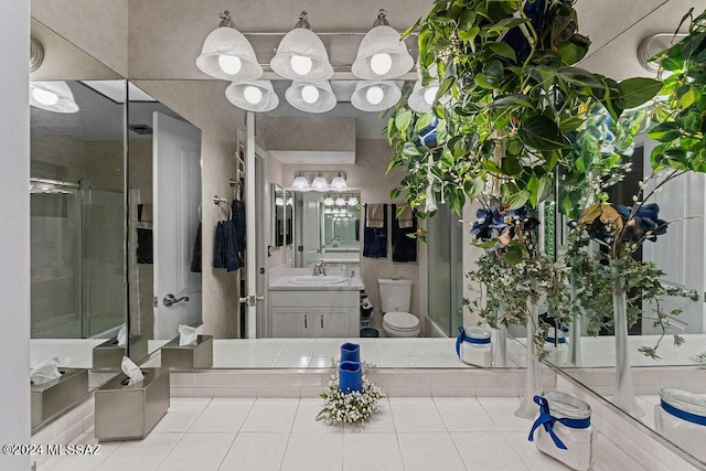 full bathroom featuring toilet, a stall shower, and vanity