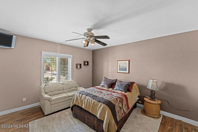 bedroom with ceiling fan and wood-type flooring