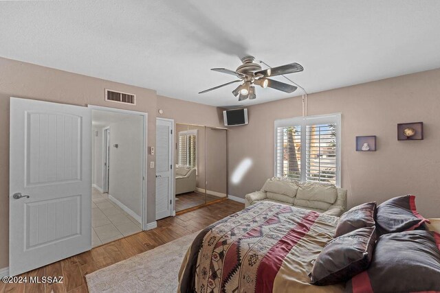 bedroom with ceiling fan and light wood-type flooring