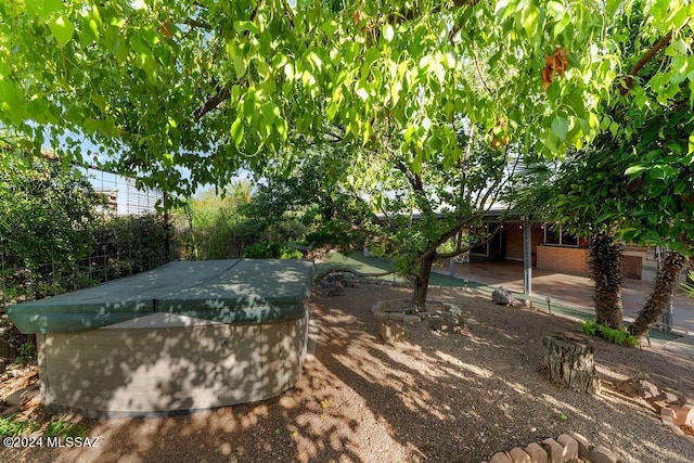 exterior space featuring a patio area and a hot tub