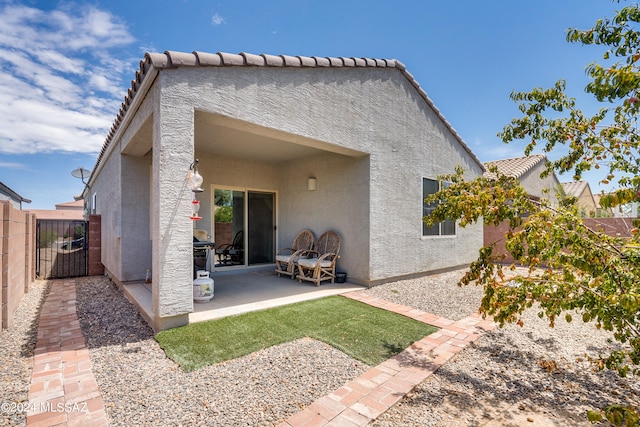 back of house with a patio