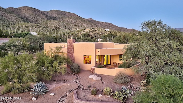 rear view of property featuring a mountain view