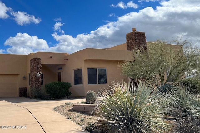 southwest-style home featuring a garage