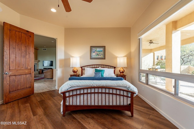 bedroom with ceiling fan and dark hardwood / wood-style floors