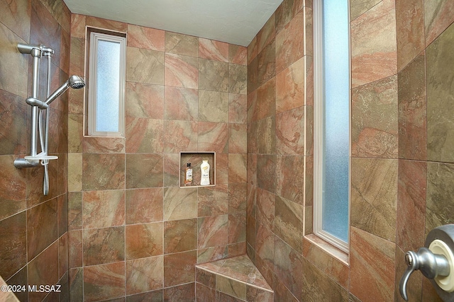 bathroom with tiled shower