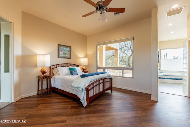 bedroom with ceiling fan, dark hardwood / wood-style flooring, lofted ceiling, and ensuite bath