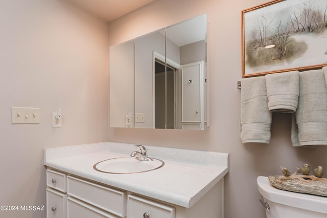 bathroom featuring toilet and vanity