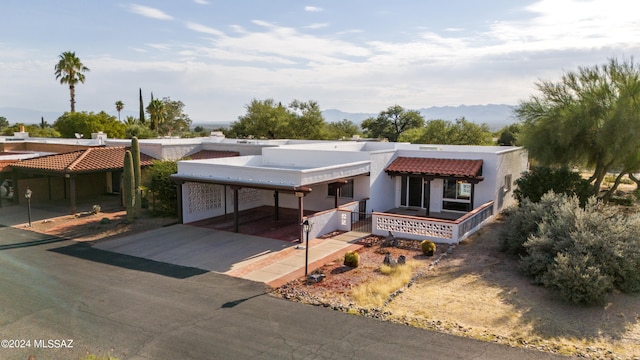 view of front of property featuring a carport and a mountain view