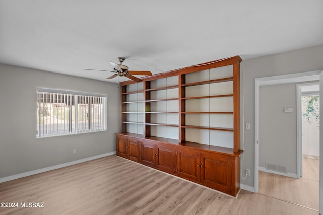 unfurnished living room with ceiling fan and light wood-type flooring