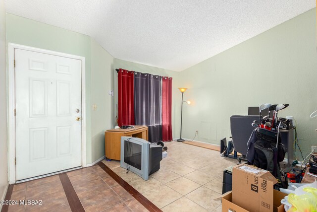 interior space featuring a textured ceiling and tile patterned flooring