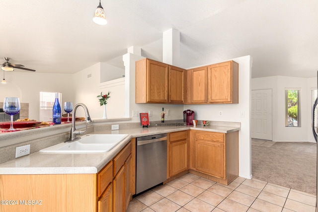 kitchen with light tile patterned flooring, kitchen peninsula, ceiling fan, stainless steel dishwasher, and sink