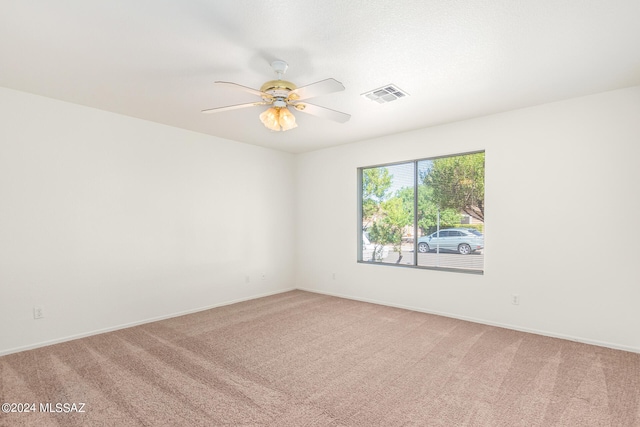 spare room with ceiling fan and carpet flooring