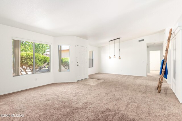 empty room featuring lofted ceiling and light carpet