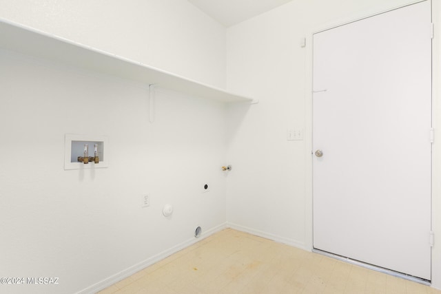 laundry room featuring washer hookup, light wood-type flooring, hookup for a gas dryer, and hookup for an electric dryer