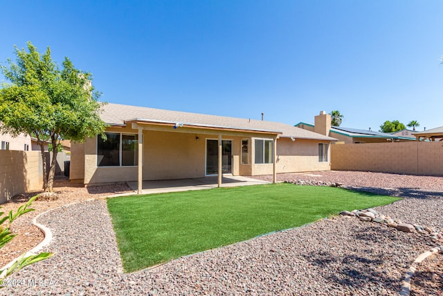 back of house featuring a yard and a patio