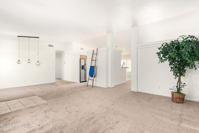 carpeted empty room with vaulted ceiling