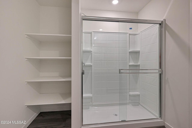 bathroom with a shower with door