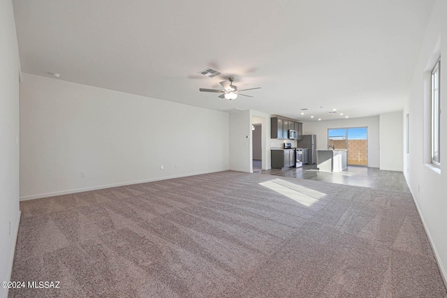 unfurnished living room with carpet floors and ceiling fan