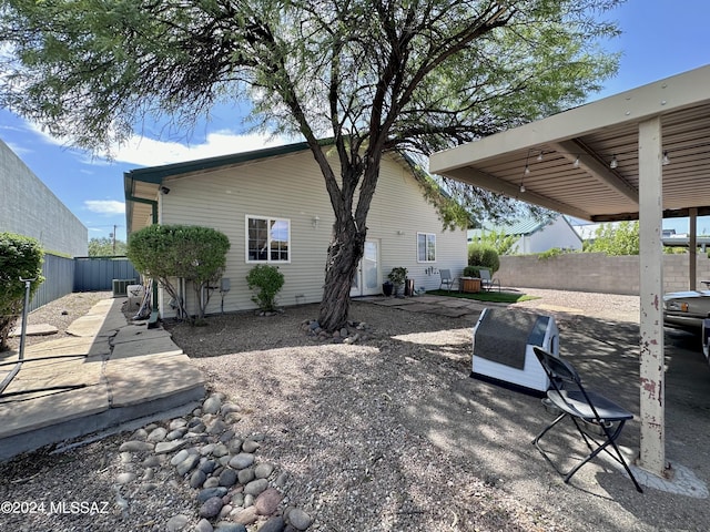 back of property with cooling unit and a patio area