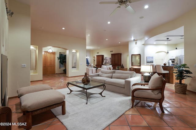 living room with ceiling fan and light tile patterned flooring