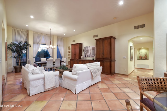 living room with a chandelier and light tile patterned floors