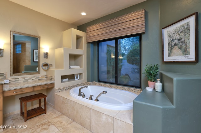 bathroom with vanity, tiled tub, and tile patterned floors