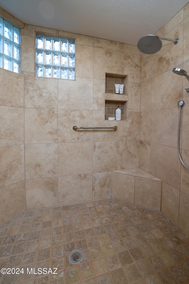 bathroom with a tile shower