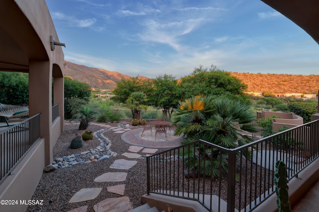 view of patio featuring a balcony and a mountain view