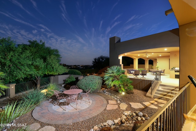 view of patio terrace at dusk