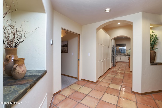 hallway with light tile patterned flooring