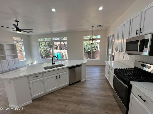 kitchen featuring white cabinetry, light hardwood / wood-style flooring, appliances with stainless steel finishes, and sink