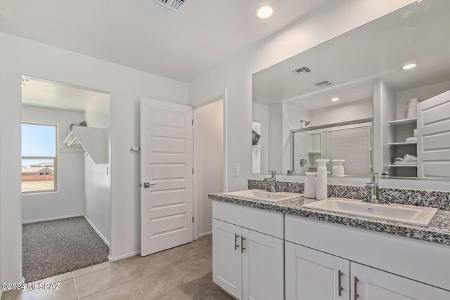 bathroom featuring tile patterned flooring and a shower with door