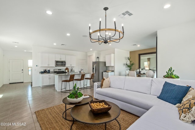 tiled living room featuring an inviting chandelier