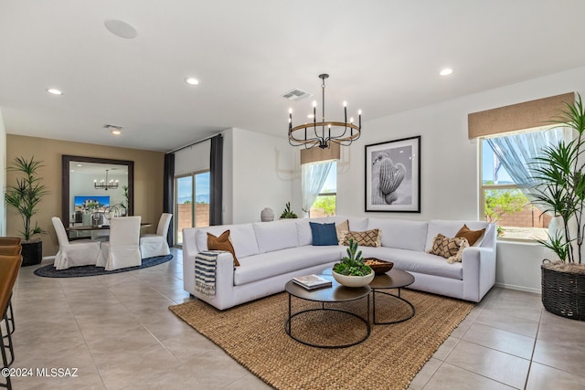 living room featuring light tile patterned flooring and a chandelier