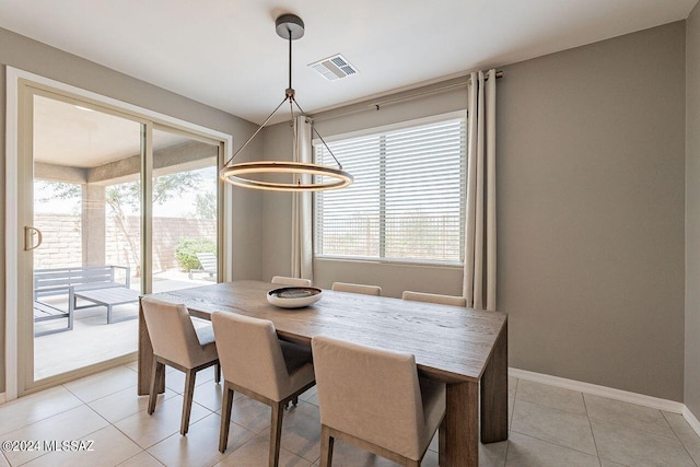 dining area featuring light tile patterned floors, baseboards, and visible vents